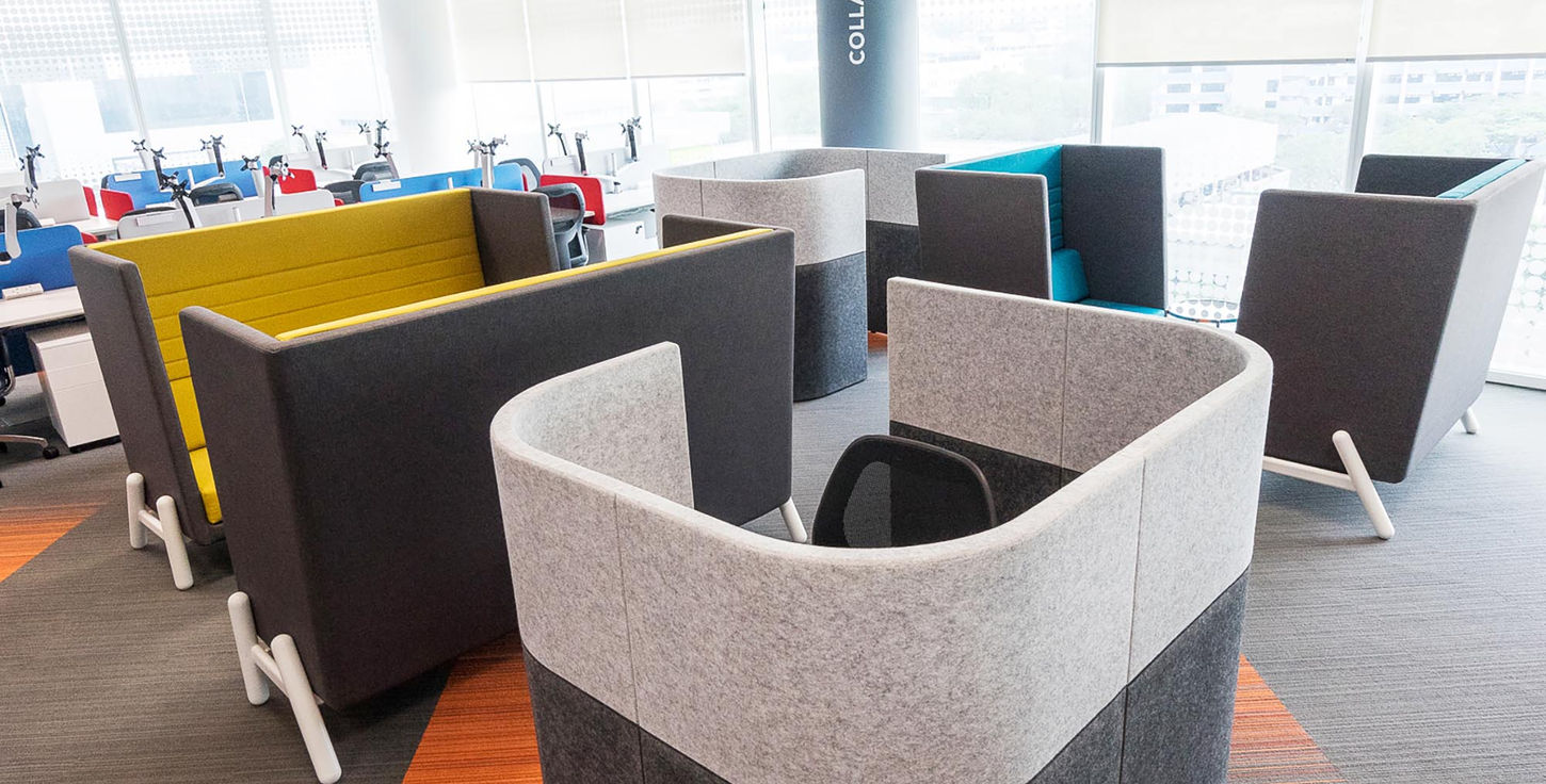 office with various chairs surrounding a table, creating a functional area for meetings