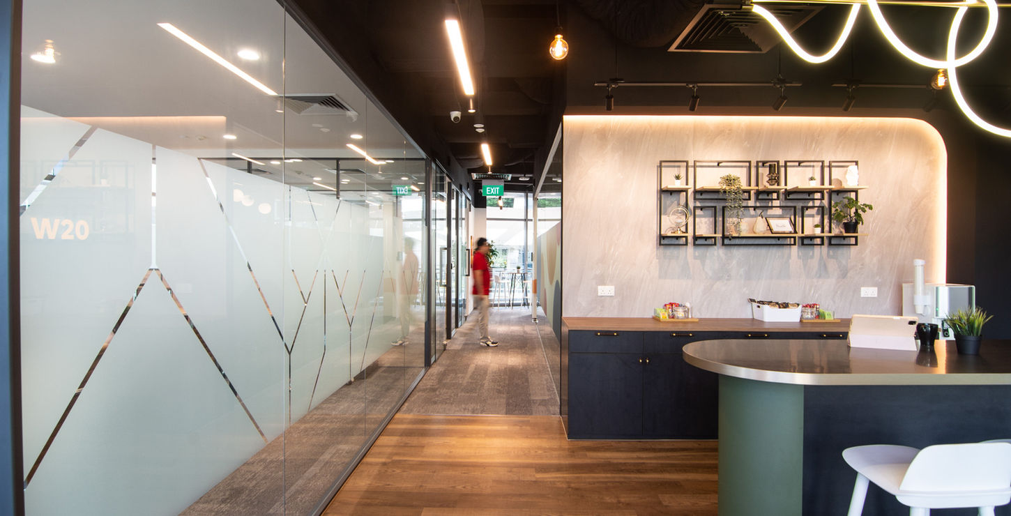 sleek office pantry with a bar and glass wall