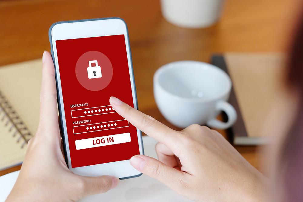 woman entering login info on phone - mobile security