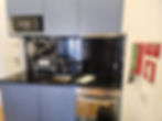 Modern apartment kitchen with microwave, sink, and oven