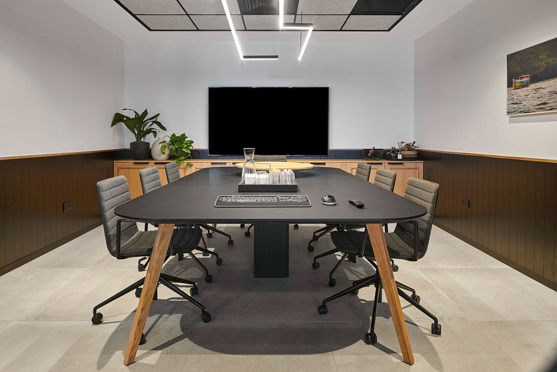Modern conference room with large table and screen