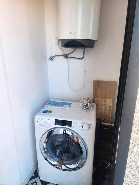 Apartment laundry room: washer, water heater