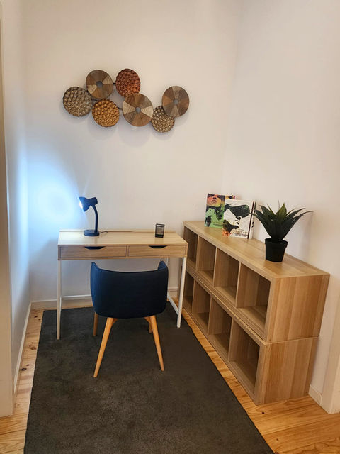 Modern home office with desk, chair, and shelving