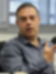 Man in blue shirt speaking, gesturing