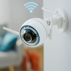 Wireless security camera installed on wall