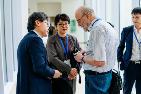 Three international delegates discussing