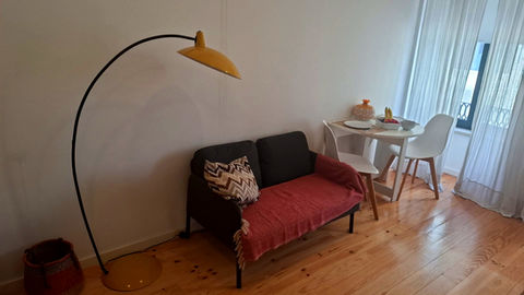 Stylish apartment living room with sofa and small dining area