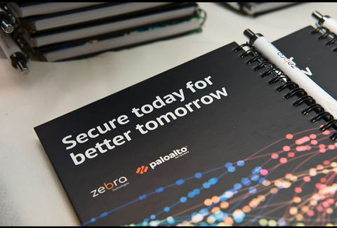 מחברת עם הכיתוב: "Secure today for better tomorrow", לוגו של Palo Alto ו-Zebra Technologies