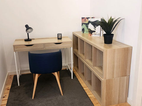 Modern home office: desk, chair, and shelving unit