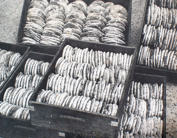 Stacks of salt cakes drying in wooden crates
