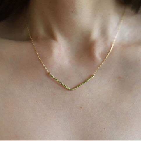 Minimalist V necklace in 24k gold vermeil, a modern chevron statement piece hand-assembled in Canada by Shokoro Handmade