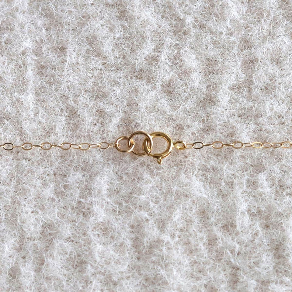 Close-up of 14k gold filled necklace clasp and chain end. High-quality artisan jewelry detail. Shokoro Canada.