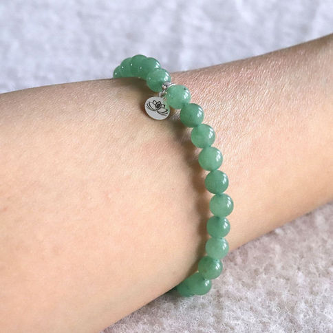 Wearing a Green Aventurine bracelet for opportunity. Minimalist heart chakra jewelry for quiet luxury styling. Shokoro.