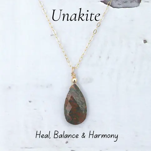 Gold filled delicate chain with teardrop Unakite pendant. Text reads "Unakite" and "Heal, Balance & Harmony." Elegant".