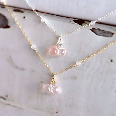 Angled close-up of handcrafted Rose Quartz station necklace showing faceted 3mm beaded chain and puffy gemstone drops by Shok