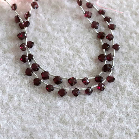 High-quality natural garnet beads in strands, featuring natural radiance for layering station necklace.