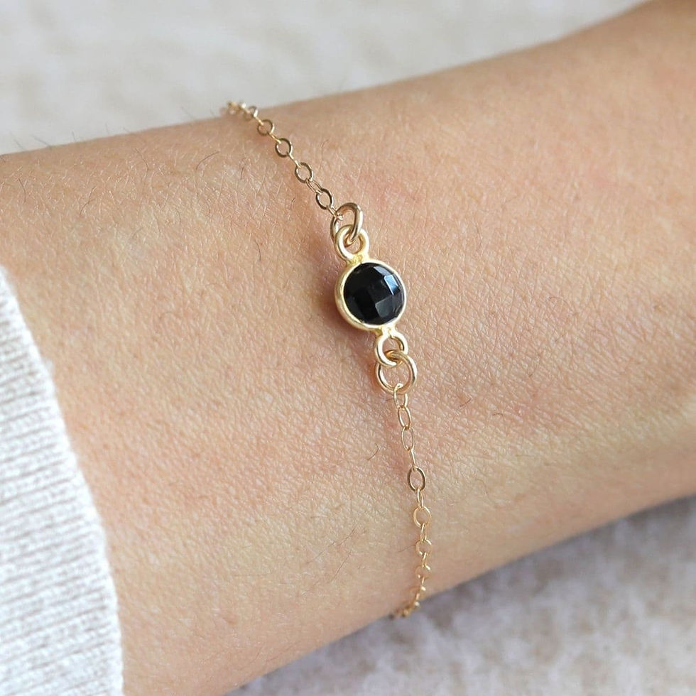 Delicate Black Onyx bracelet styled on wrist. Minimalist gold jewelry for quiet luxury stacking. Shokoro Handmade Canada.