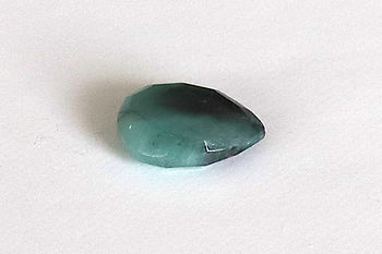 AAA grade Emerald teardrop stone from the Shokoro Handmade collection, illustrating the natural healing properties and intention for heart-centered and unconditional love.
