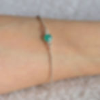 Close-up of high-quality Green Onyx bezel silver bracelet, minimalist quiet luxury talisman jewelry, artisan simplicity gift.