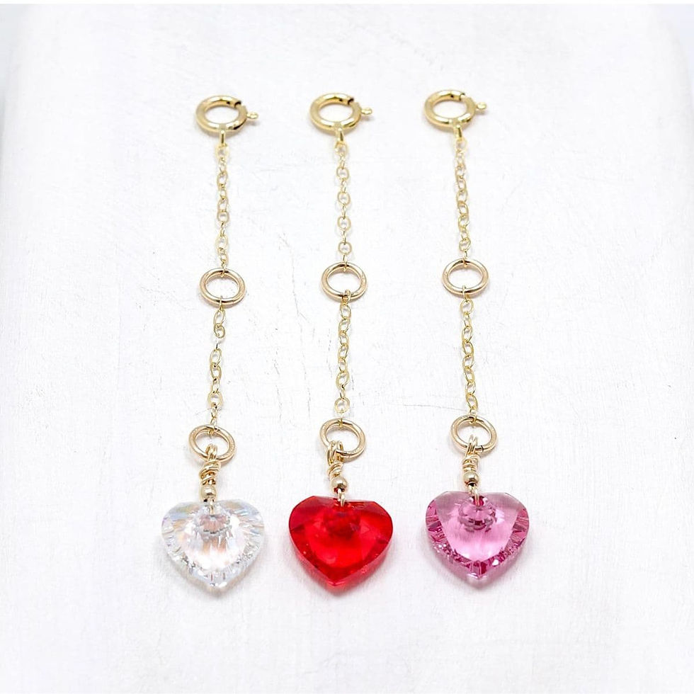Three 14k gold filled chains with Swarovski heart charms—clear, red, and pink. Minimalistic and elegant design.