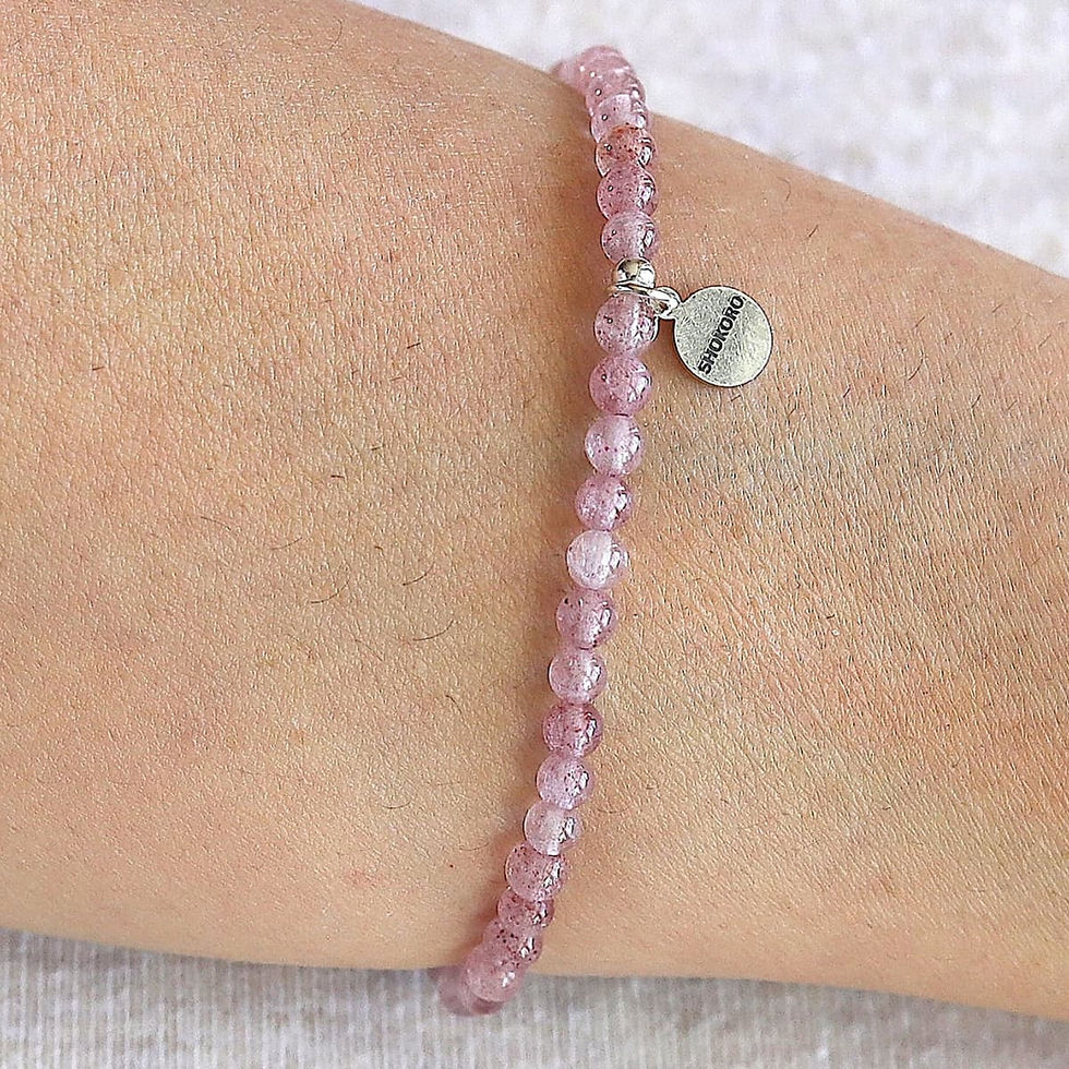 Wearing a Strawberry Quartz bracelet for love and joy. Minimalist pink crystal jewelry for quiet luxury styling. Shokoro.