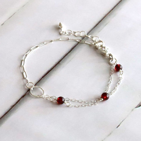 Close-up, Garnet mixed chain bracelet in sterling silver, half paperclip and half gemstone station chain, handmade gift.