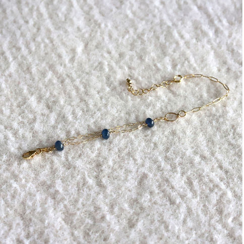 Natural sapphire bracelet displayed in an elegant arch highlighting the custom hand-hammered figure-8 wire connector.