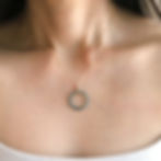 Close-up wearing a natural jade circle necklace with delicate 14k gold filled chain, handcrafted by Shokoro in Toronto.
