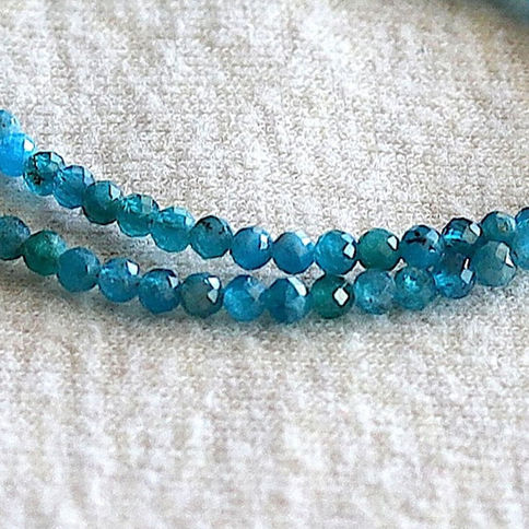 Close-up of 3mm natural Blue Apatite beads. High-quality micro-faced blue gemstones for minimalist collection from Shokoro.