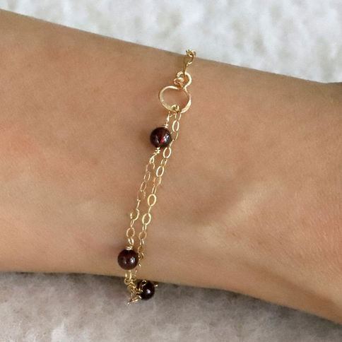 Wearing a Garnet station and paperclip chain with a infinity connector, handcrafted from Shokoro for stacking intention.