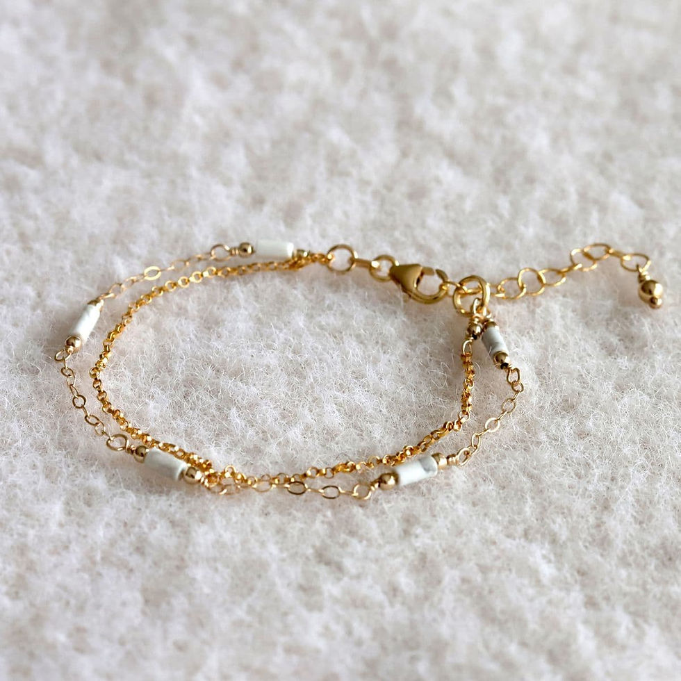 Close-up view of a handcrafted Howlite double layer chain bracelet, showcasing a simple rolo chain and a station chain
