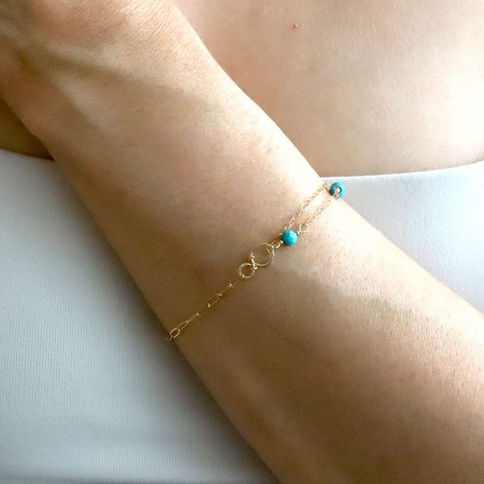 Model wearing a high quality turquoise paperclip chain gemstone bracelet in 14k gold filled, serene and minimalist vibe.