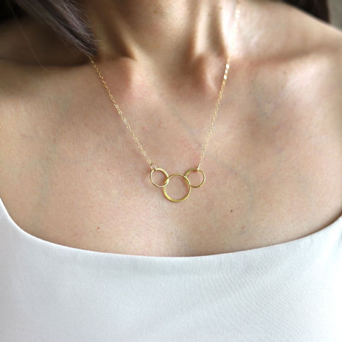 Dainty gold vermeil interlocking circle necklace shown from the front to highlight the elegant, high-quality finish in Canada