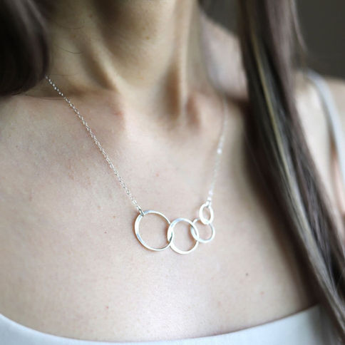 Authentic hammered four circle necklace with delicate chain, showcasing unity and bond in symbolic pendant for layering piece