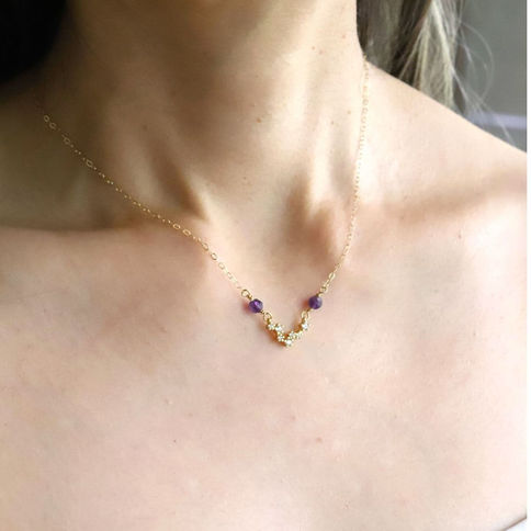 Model wearing gold-filled Pisces zodiac constellation necklace with natural gemstones. Quiet Luxury minimalist style.