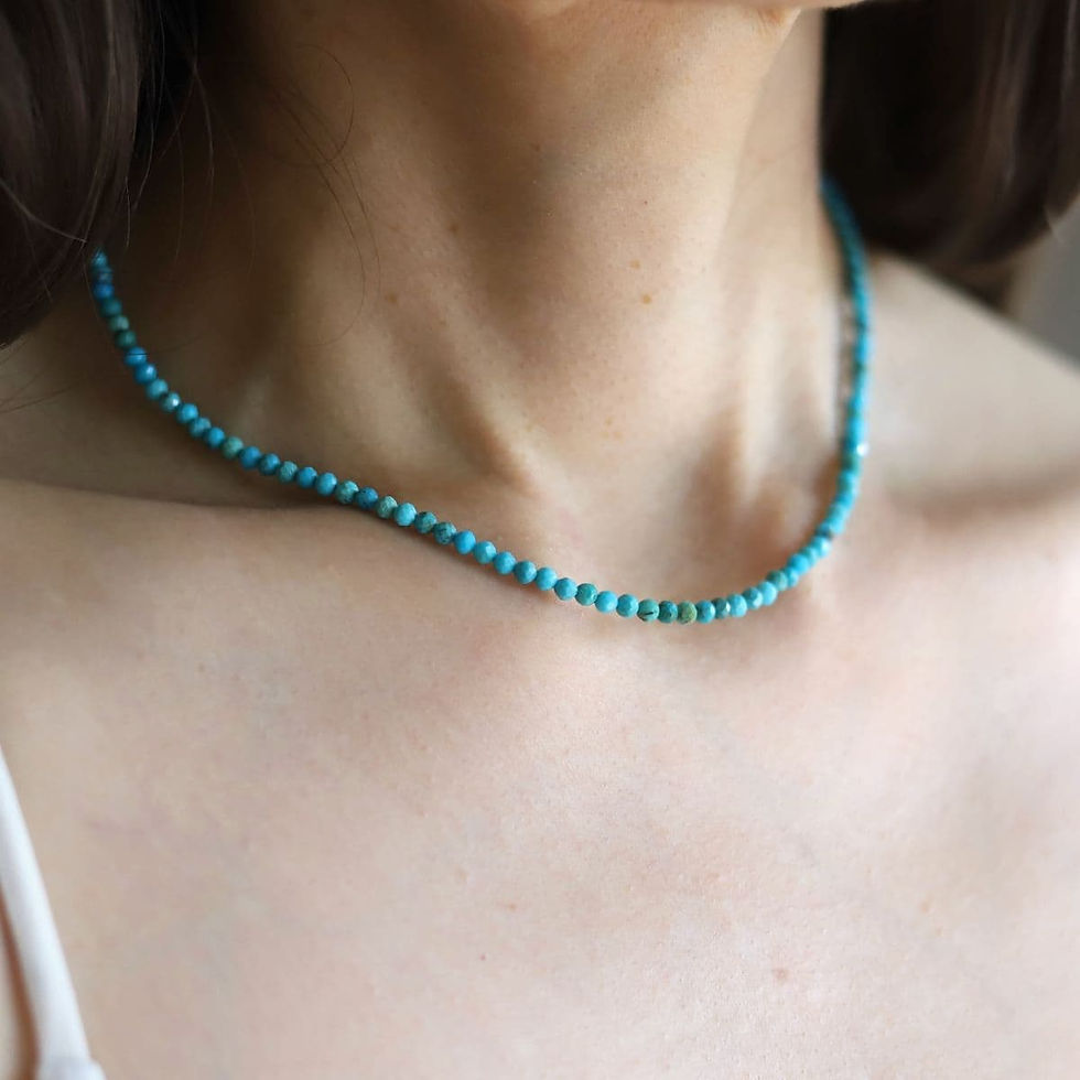 Angled, wearing a delicate Arizona Turquoise gemstone strand necklace, vibrant gemstone and everyday luxury styling.