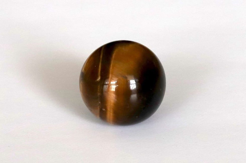 Natural Tiger Eye round stone from the Shokoro Handmade private collection, illustrating the natural healing properties and intention for protection and grounded power.