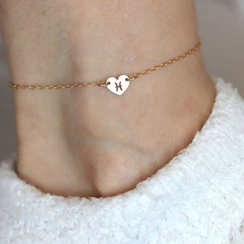 Pisces zodiac water sign heart anklet on model. Soulful 14k gold filled layered look by Shokoro Handmade.