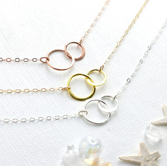 These Love of Double Circle Necklace are the epitome of elegance. Crafted with delicate interlocking circles in gold, rose gold, and silver, it adds a touch of sophistication to any outfit. There is an option to choose an extender chain, allowing you to adjust the length to suit your style. Whether you're going for a minimal fashion look or dressing up for a special occasion, this necklace is the perfect accessory. Plus, it's thoughtfully packaged with care.