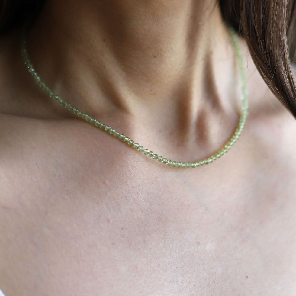 Wearing a delicate Peridot beaded necklace, artisan detail and sparkling gemstone, quiet luxury layering gift for her.