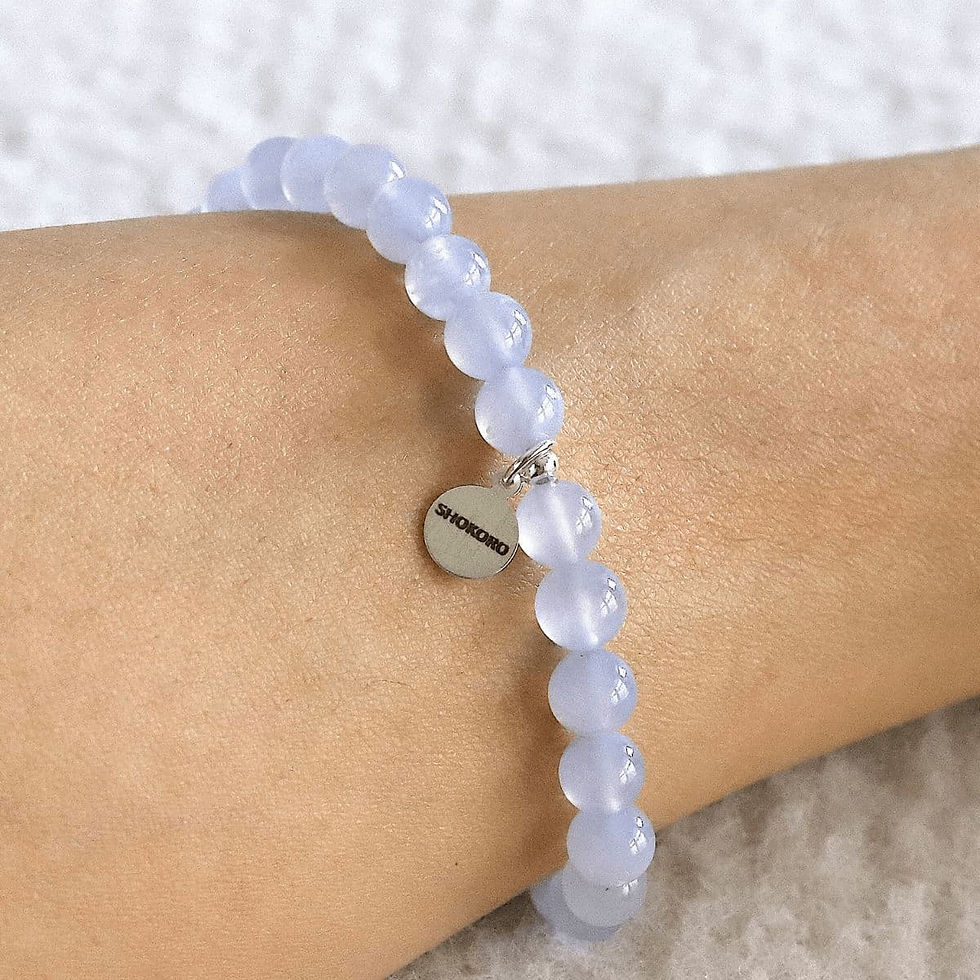 Wearing a dainty 6mm Blue Chalcedony bracelet. Minimalist sky blue crystal jewelry for emotional balance and quiet luxury sty
