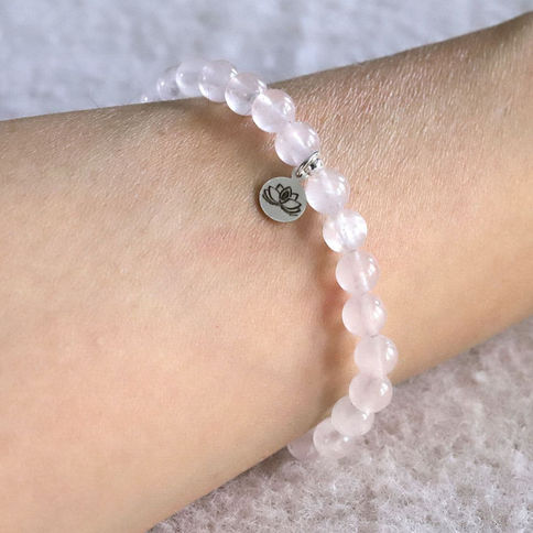 Wearing a natural Rose Quartz bracelet. Dainty crystal jewelry gift for a friend. Shokoro Handmade Canada.