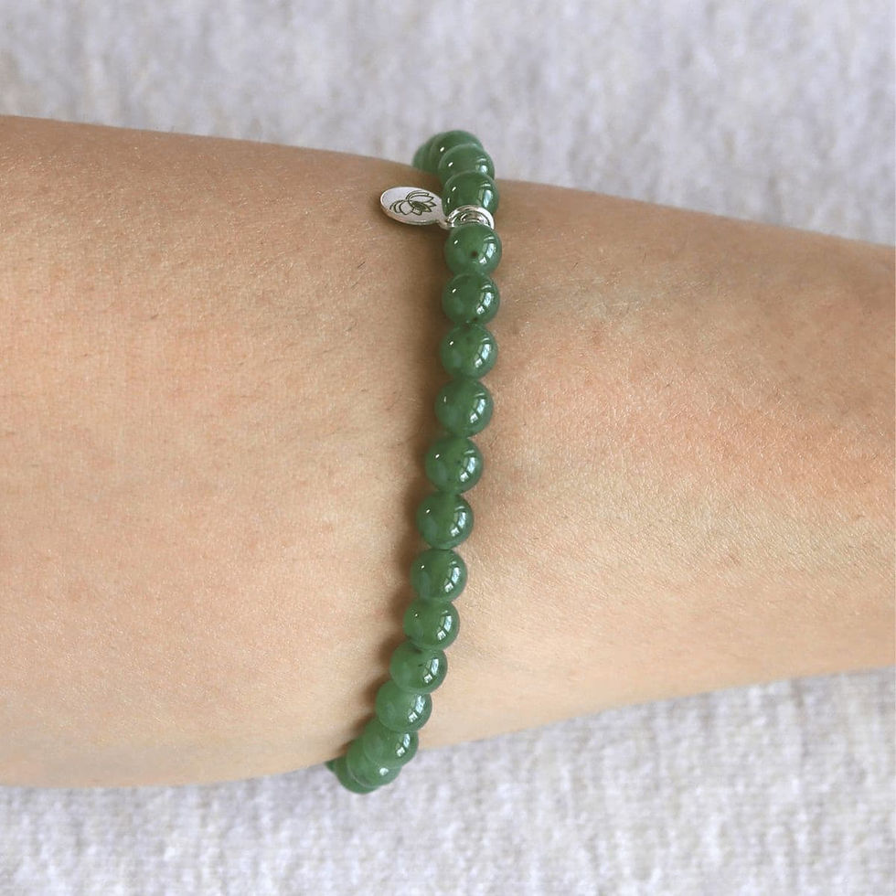 Wearing a genuine Hetian Green Jade bracelet with asilver tag. High-quality nephrite jade jewelry Toronto, Ontario.