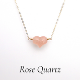 Discover the enchanting allure of the Shokoro Crystal Jewelry Collection, where elegance meets heartfelt meaning. Among its treasures lies the Rose Quartz Puffy Heart Pendant Necklace, a piece that not only adorns but also resonates with the spirit of love and compassion.  This exquisite necklace showcases an AAA-grade natural rose quartz, meticulously hand-carved into a charming heart shape, measuring approximately 18mm x 16mm x 10mm. Suspended on a luxurious 14k gold-filled chain, this necklace is a testament to minimalist beauty and expert craftsmanship. The soft pink hue of the pendant exudes warmth, making it a versatile accessory for any outfit, whether it’s a casual day out or a special evening event.  But this piece is more than just a beautiful accessory. The rose quartz, known as the "Stone of Love," radiates a soothing pink energy that nurtures the heart. It embodies unconditional love and inner peace, melting away negative emotions. This powerful crystal is believed to strengthen the physical heart and circulatory system, promoting overall well-being. As a Heart Chakra stone, it opens pathways to compassion, forgiveness, and self-love, inviting you to embrace its calming presence in your life.  The heart symbol itself is a universal emblem of love, pulsating with profound meaning. It transcends cultures, radiating warmth and affection, and serves as a gentle reminder of our capacity to care deeply for others. The rounded curves of the heart symbolize empathy, while its pointed base signifies the intensity of emotion. In a world where connection is vital, this timeless symbol encourages acts of love that ripple outward, touching lives and fostering a compassionate society.  Elevate your jewelry collection with the Rose Quartz Puffy Heart Pendant Necklace and let it be your companion on the journey to a more loving, peaceful self. Explore the beauty and significance of this remarkable piece today, and embrace the harmony it brings to your life.