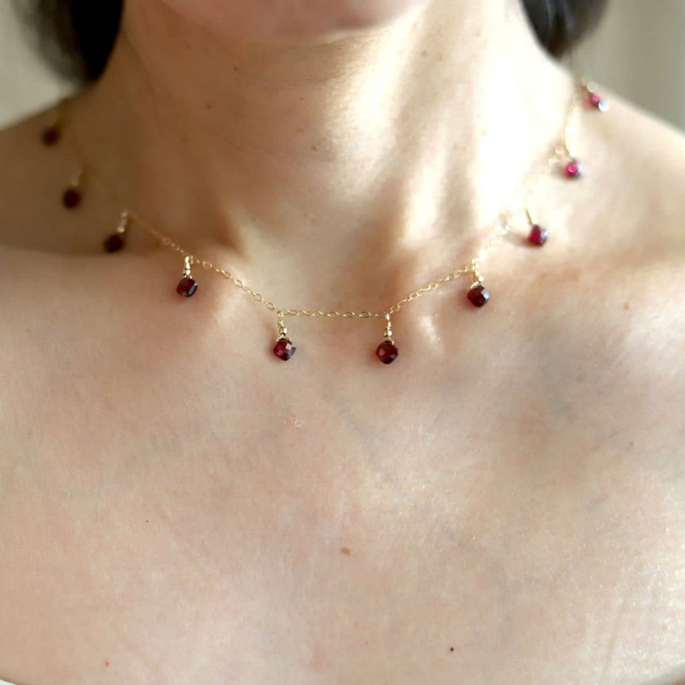Close-up wearing a handmade natural garnet station choker necklace with dainty 14k gold filled chain, Toronto, On Canada