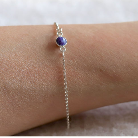 Close-up of delicate Sapphire crystal bracelet. Sterling silver dainty birthstone jewelry made in Toronto, Ontario, Canada.
