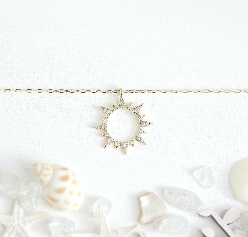 Sun-shaped gold necklace with diamonds on white background, Delicate and minimalist jewelry. Bright and elegant.