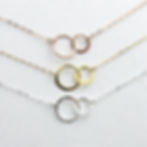 Double circle necklace in 14k gold-filled, rose gold-filled and sterling silver by Shokoro Handmade, symbolizing love bond.