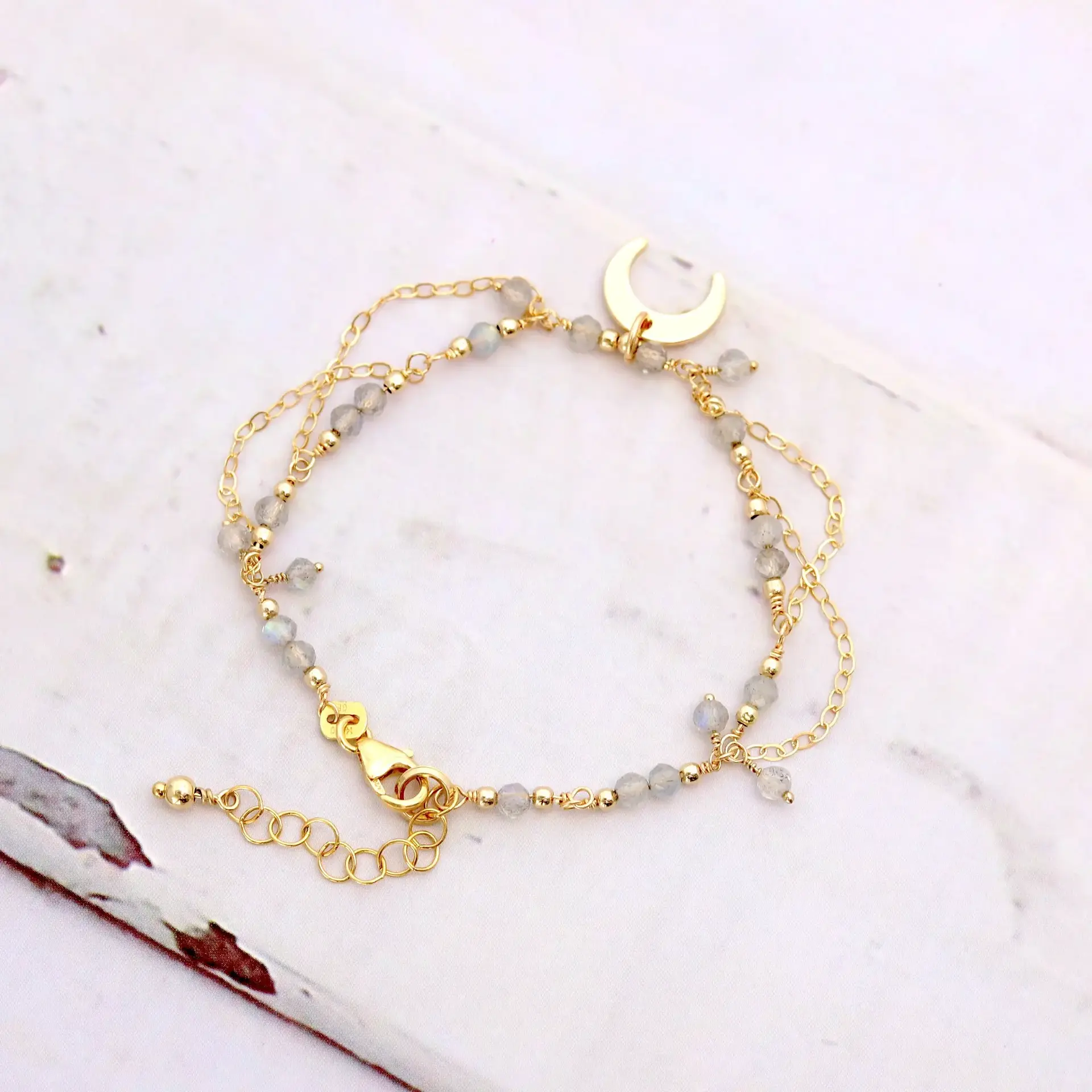 Gold upside down moon and labradorite bracelet, showing craftsmanship and high-quality natural gemstone, serene and feminine design.