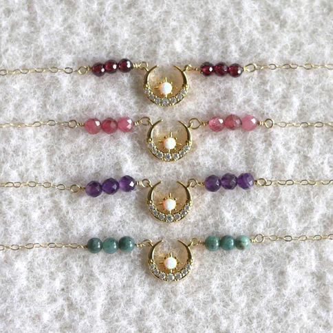 Gold crescent moon and star pendant necklace with cubic zirconia and a center opal with dainty chain and natural gemstones.